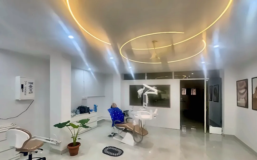 Treatment room with a dental chair beneath a circular ceiling light at Supriya Multispeciality Dental Clinic
