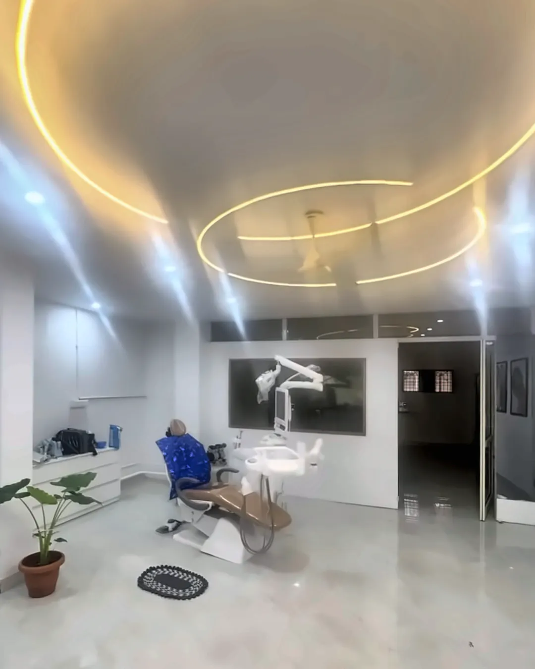 Circular golden ceiling lights above the treatment area at Supriya Multispeciality Dental Clinic